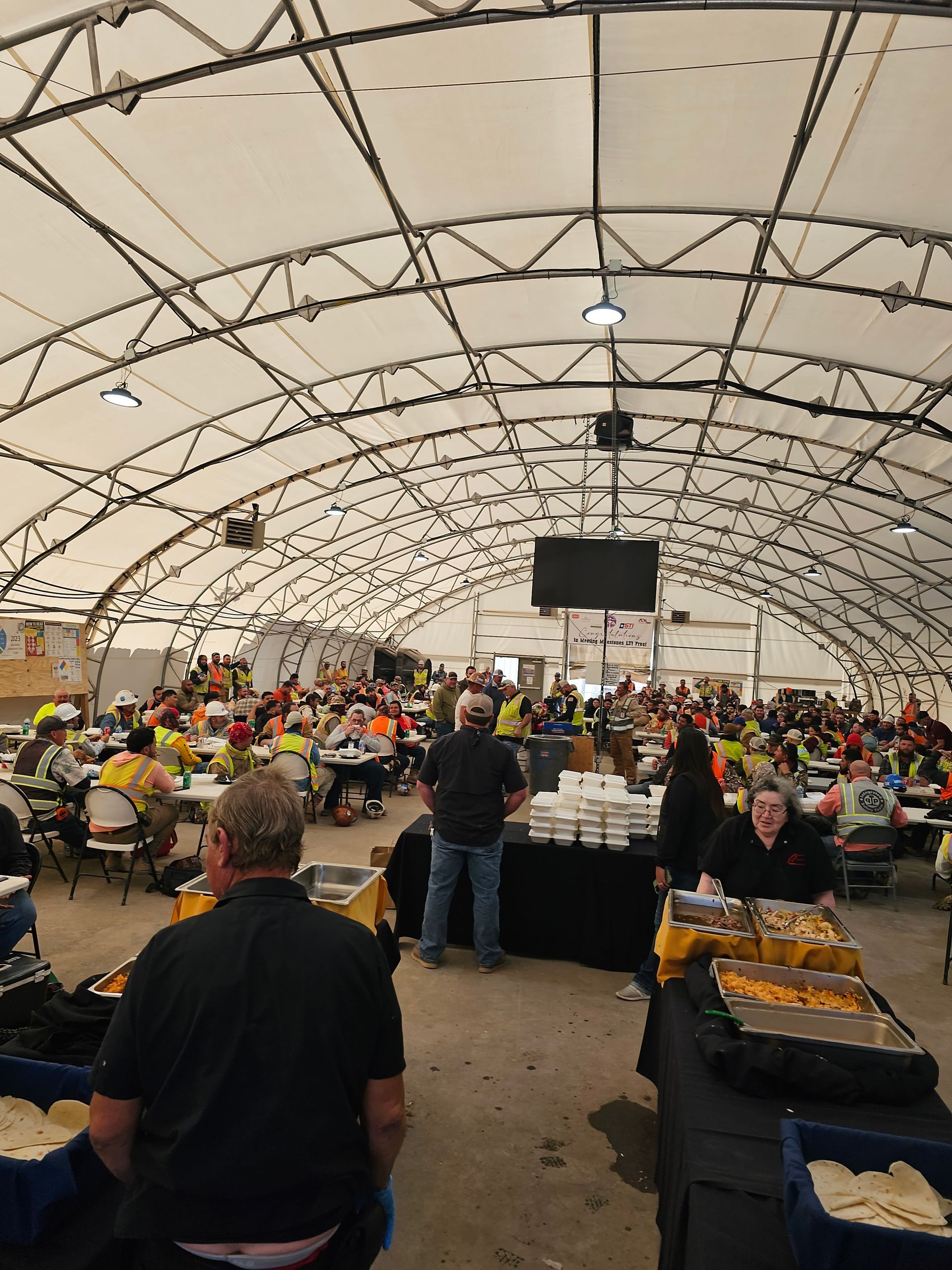 a large room with a lot of people sitting at tables