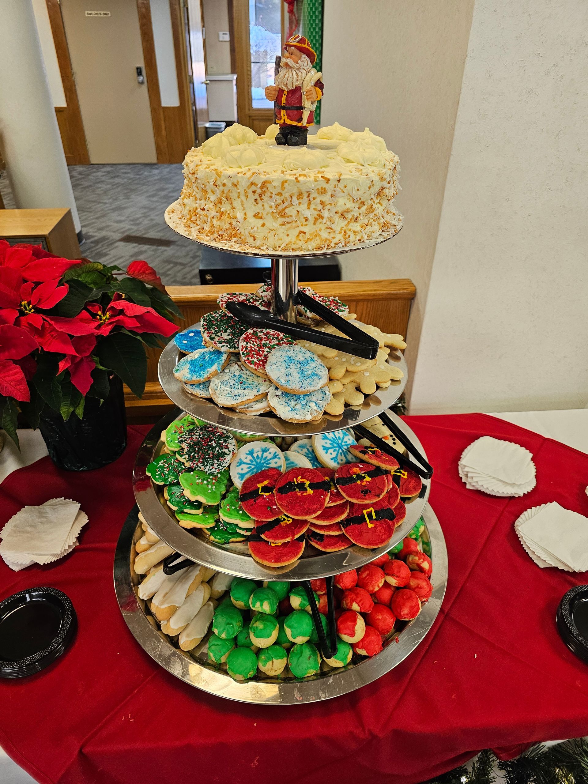 a stack of cookies and a cake on a table .