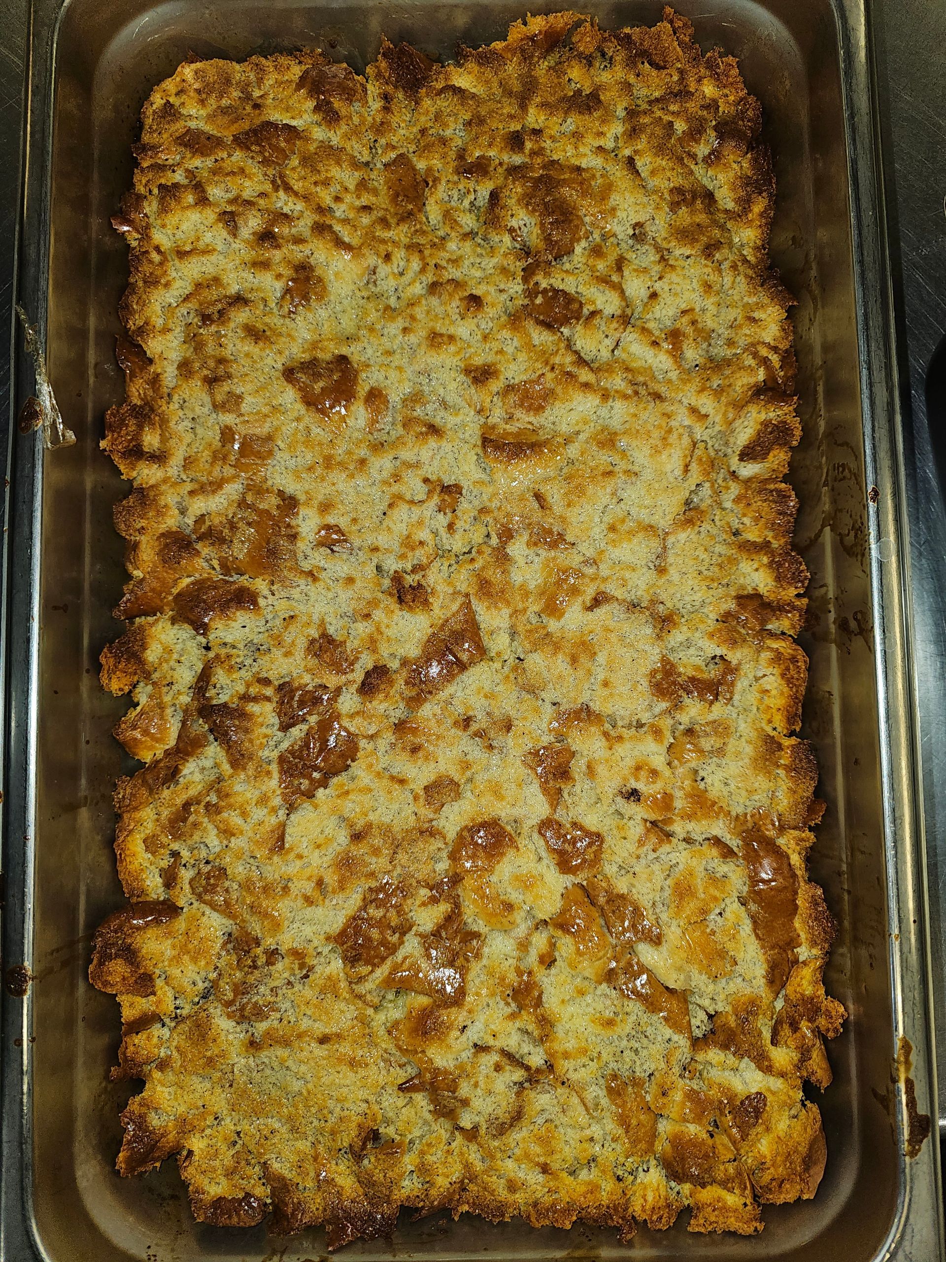 a pan of food with a lot of crumbs on it is sitting on a table .