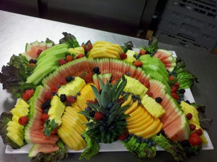 a tray of fruit including watermelon pineapple and strawberries