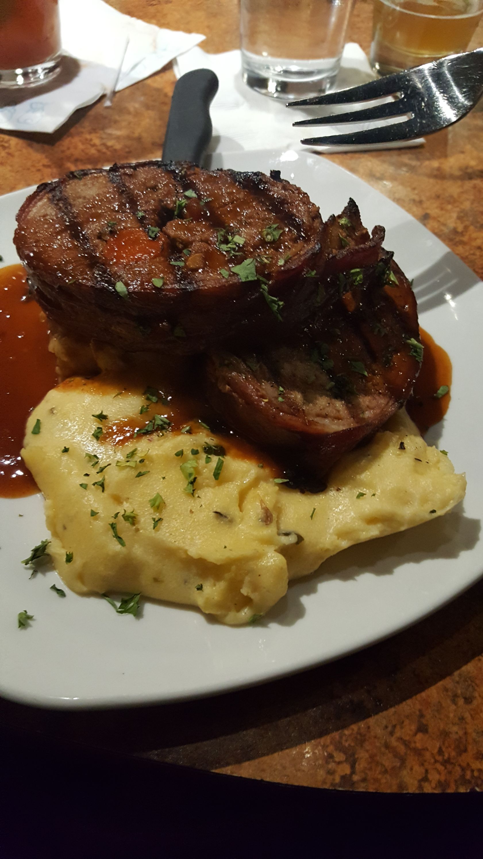 a white plate topped with meat and mashed potatoes