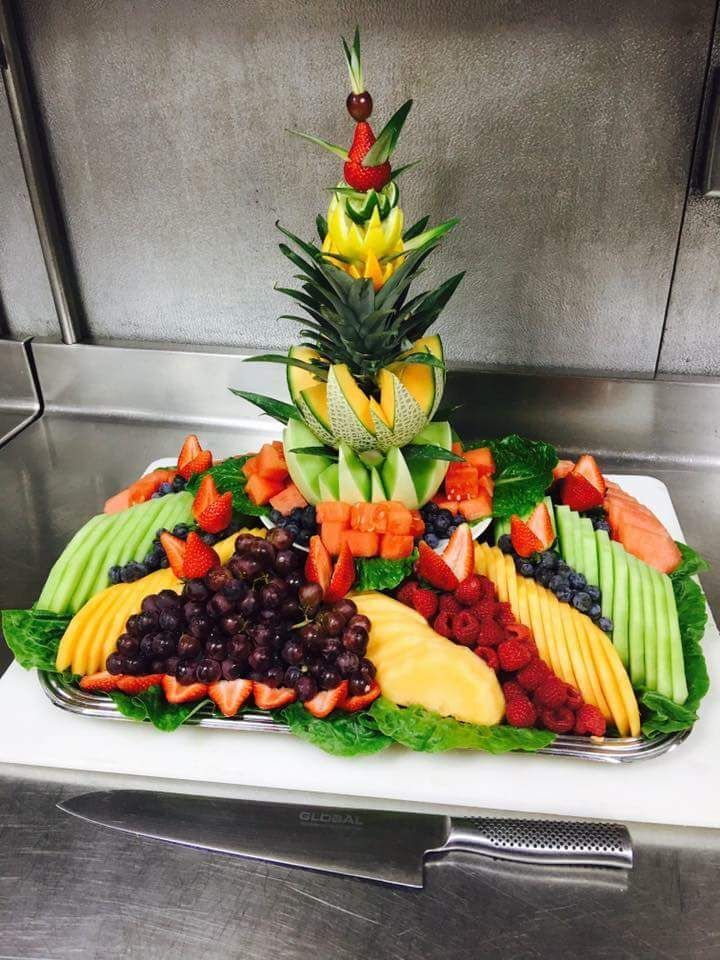 a fruit tray with a pineapple on top of it