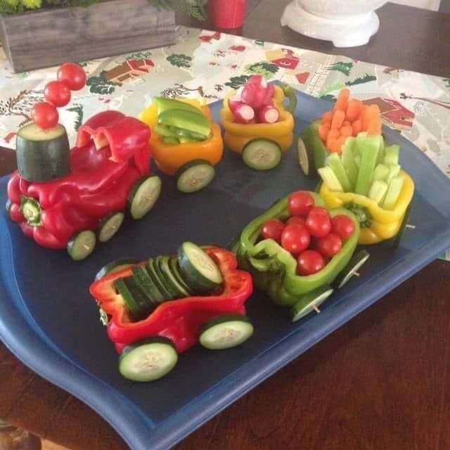 a tray of vegetables in the shape of a train