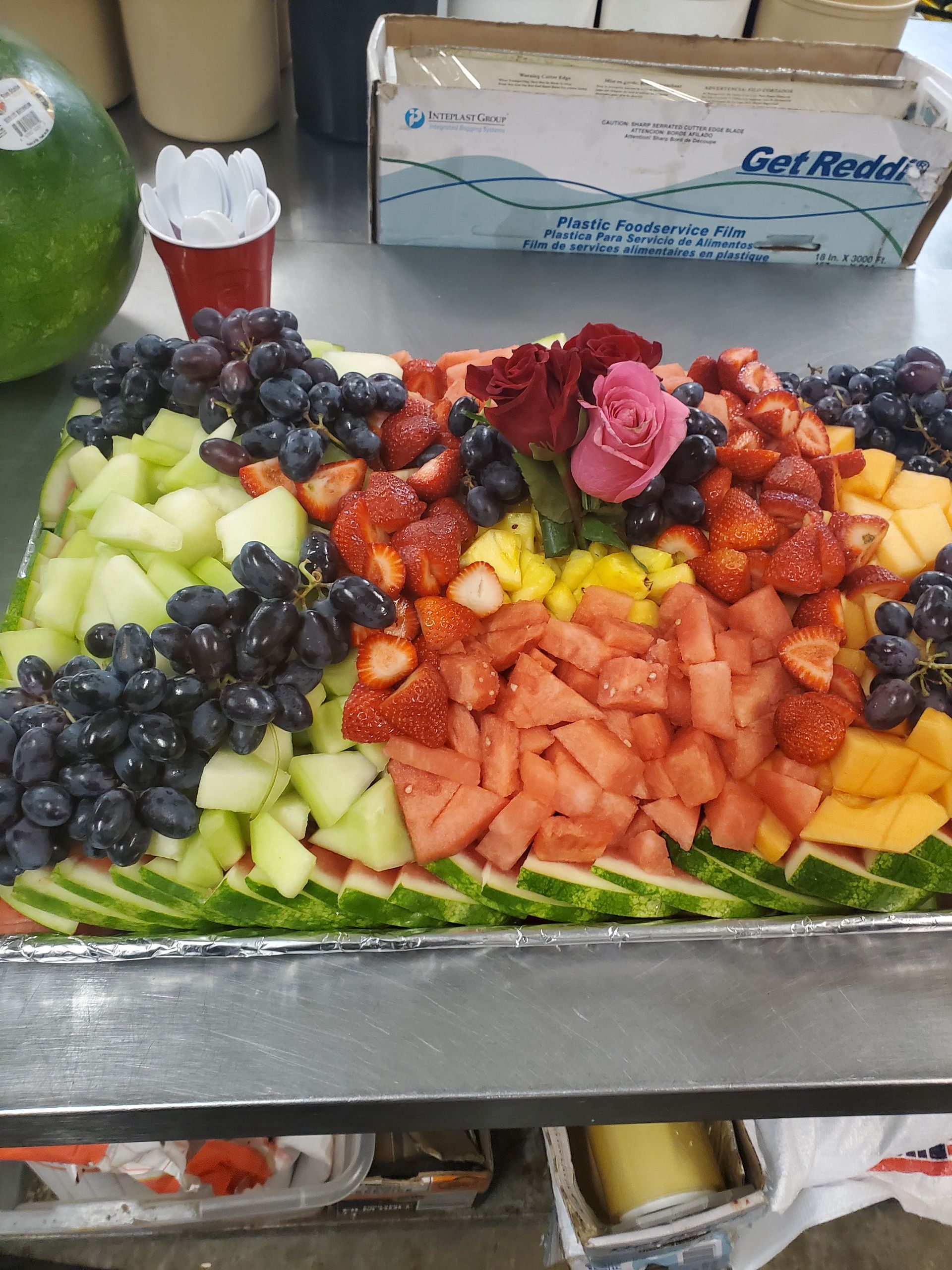 a tray of fruit including watermelon pineapple and strawberries