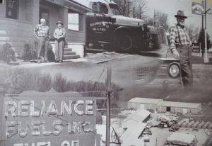 Collage of black-and-white photos showing a Reliance Fuel Service truck, workers, and a fuel station sign.