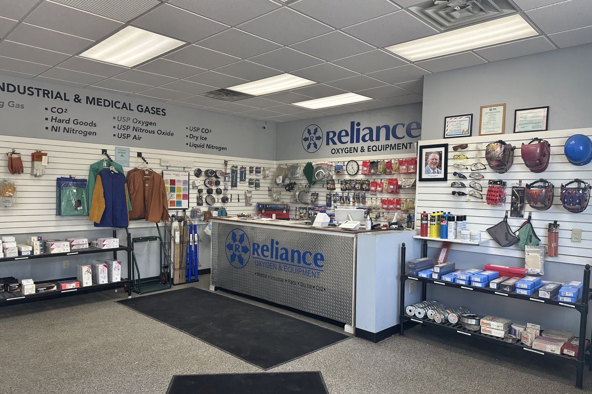 Industrial medical supply showroom with shelves of protective gear and a Reliance counter