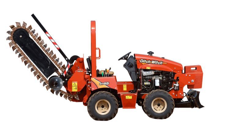 A red tractor with a chainsaw attached to it.