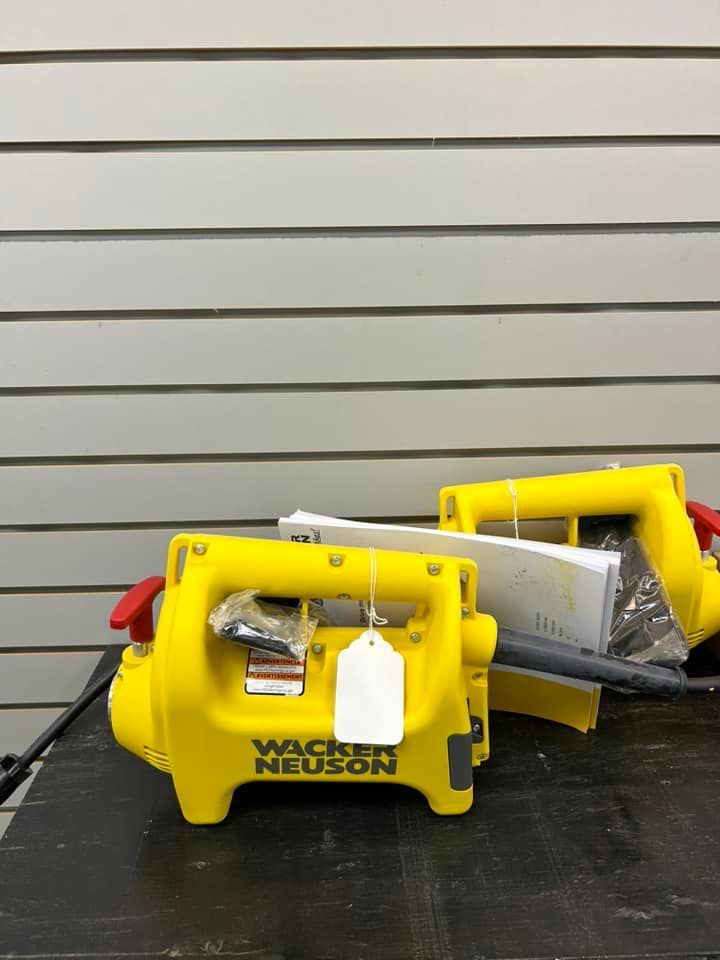 Two yellow wacker neuson tools are sitting on a table