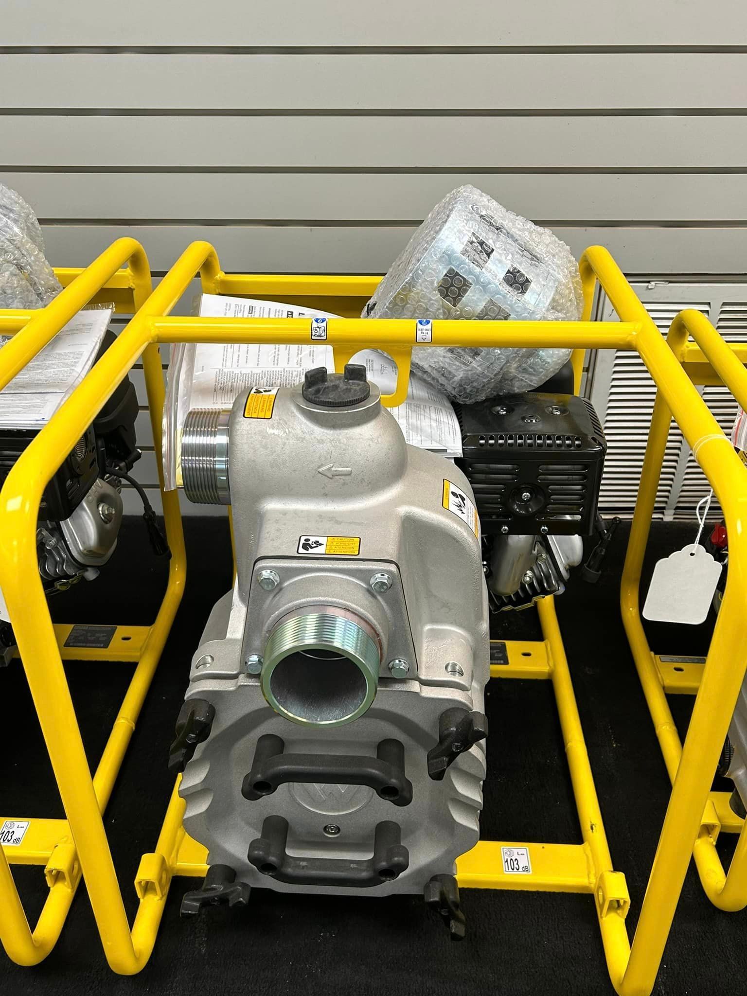 A group of water pumps sitting on top of yellow stands.