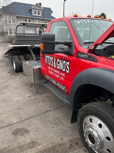 2015 Ford F-550 with the hood up is parked in front of a house