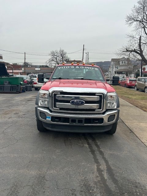A red ford truck is parked on the side of the road