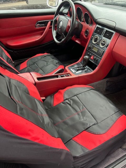 The interior of a car with red and black seats