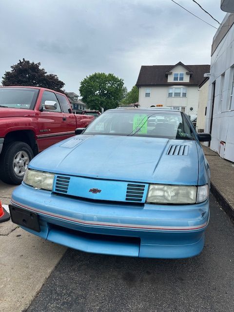 A blue car is parked on the side of the road