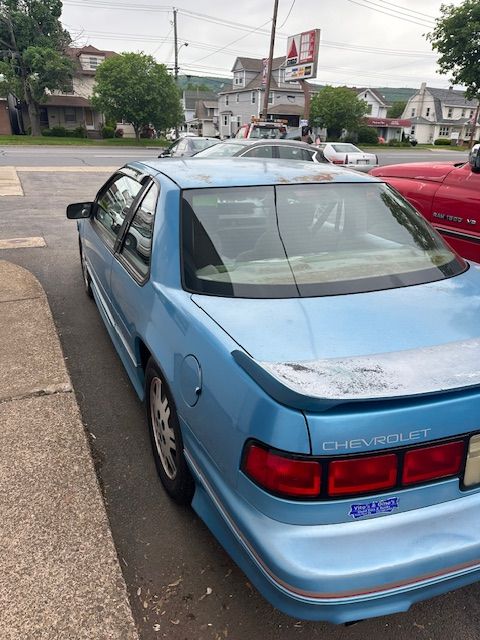 A blue chevrolet is parked on the side of the road