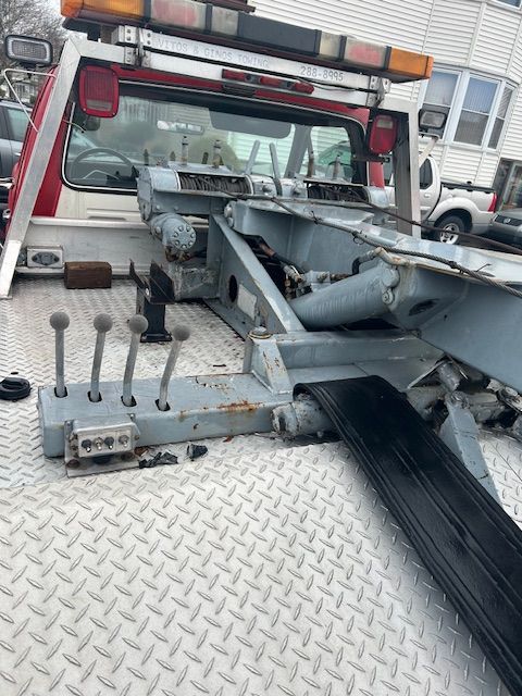 a tow truck is parked on the side of the road