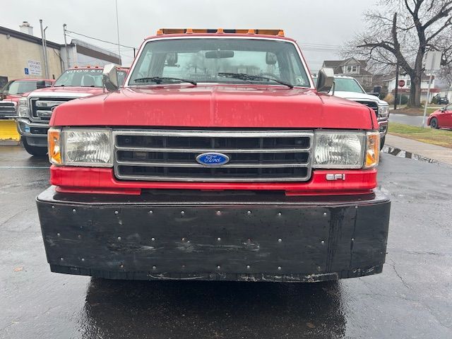 front of  red Ford truck