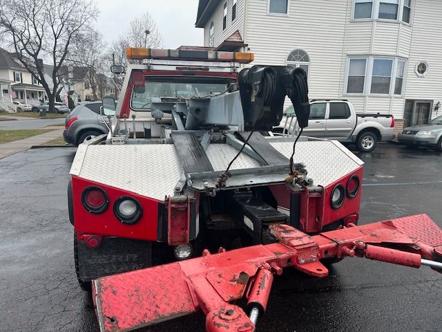 a  1989 Ford F-450 is parked in front of a house