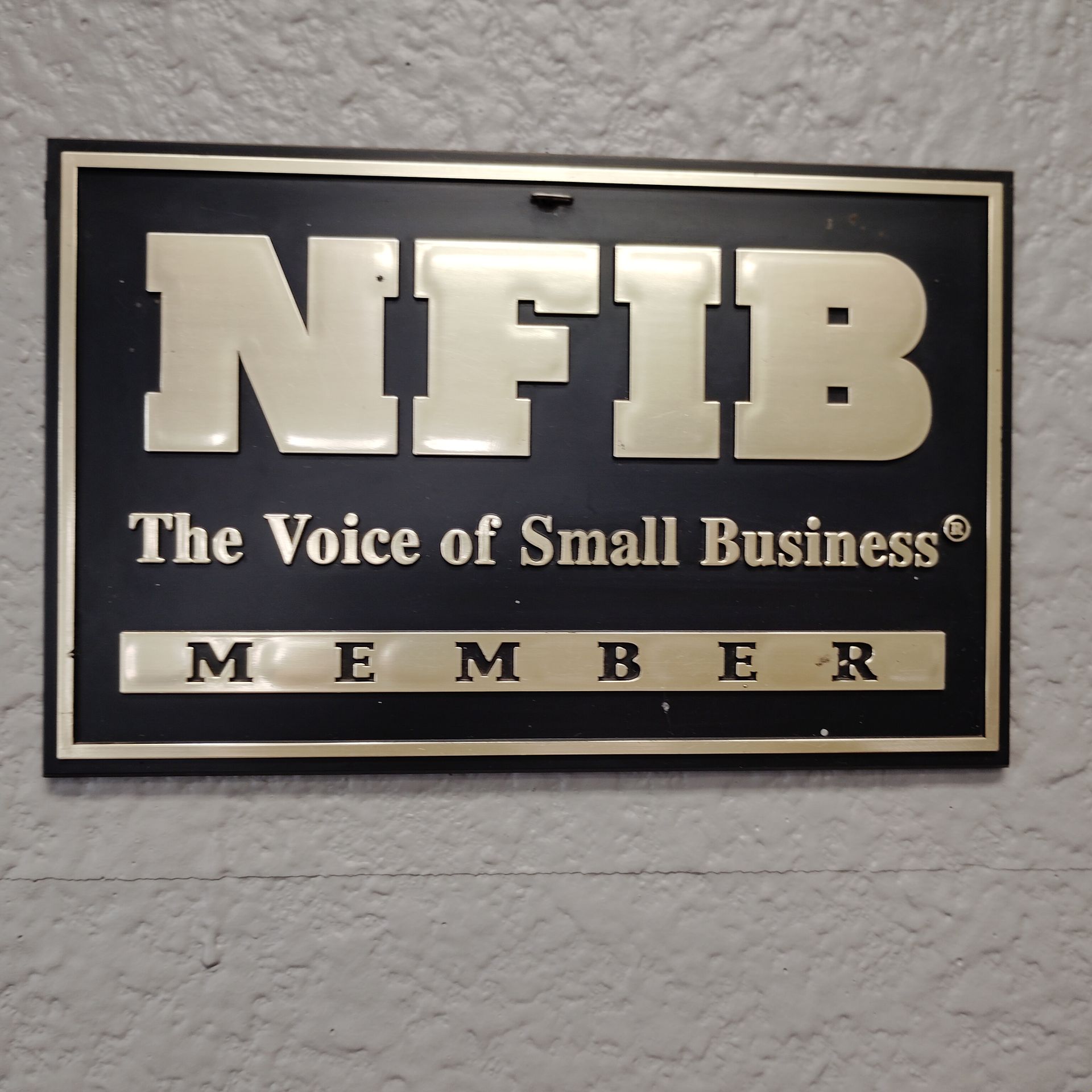 NFIB “The Voice of Small Business” member plaque on a textured wall