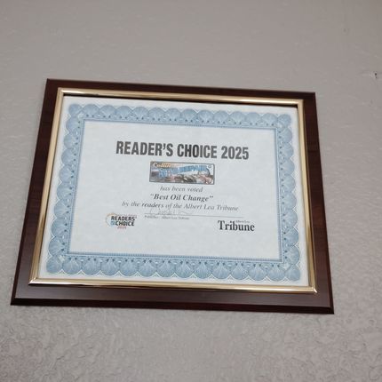 Framed “Readers’ Choice 2025” award certificate on a wall with blue border