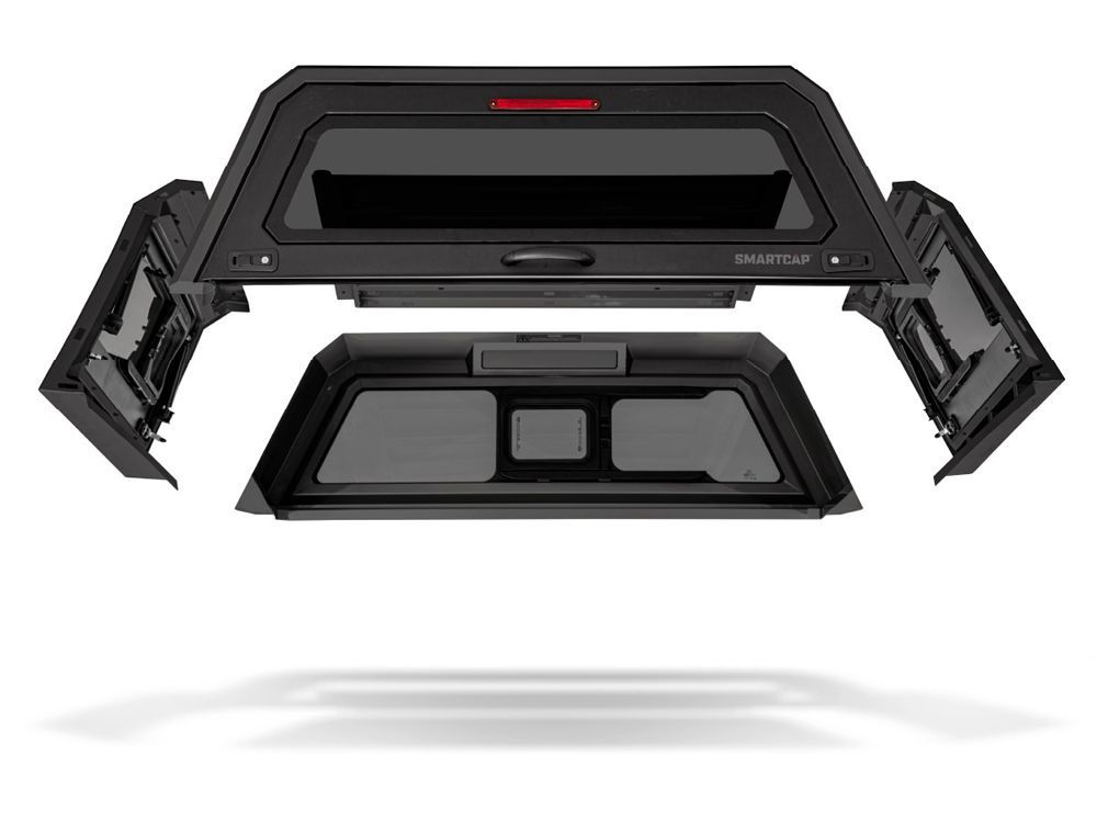 Black SmartCap truck topper, disassembled. Includes windows, doors, and a brake light.