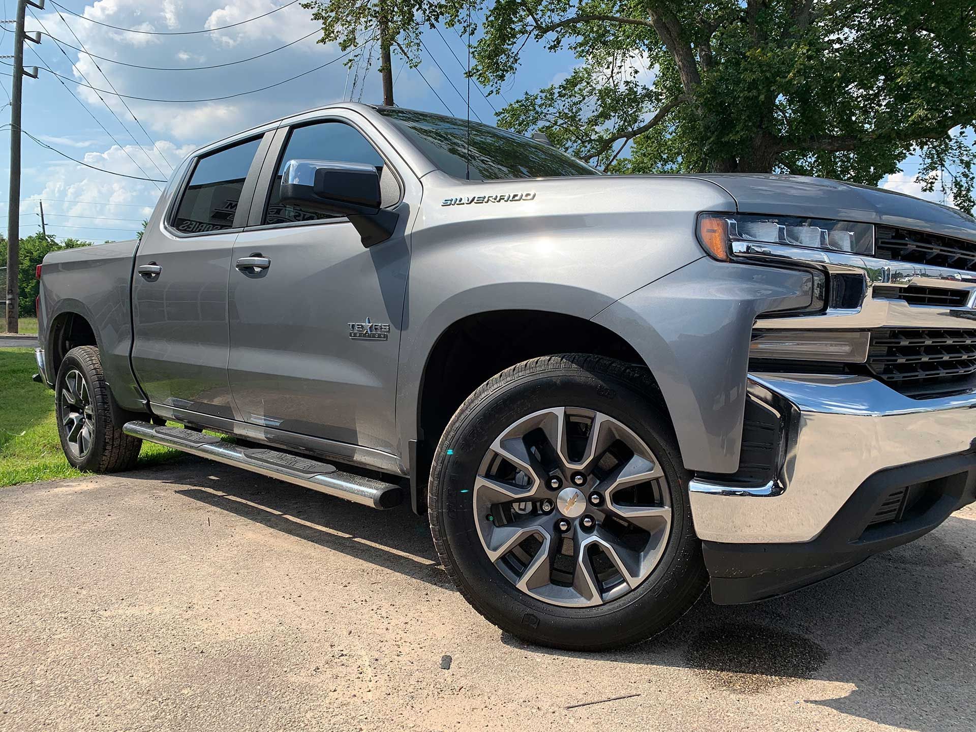 gray Chevy Silverado truck with a side step