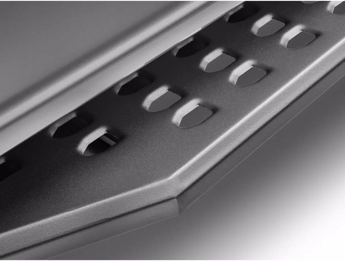 close-up of a metal step with oval-shaped cutouts for grip, angled in gray tones