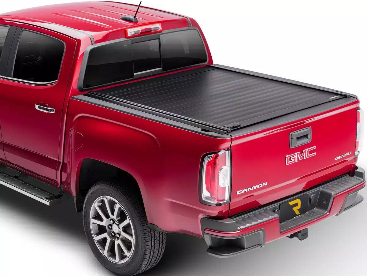 Red GMC pickup truck with a black, retractable bed cover.