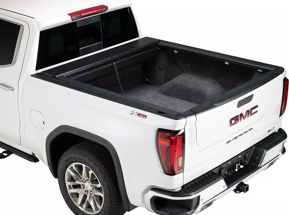 White GMC Sierra pickup truck with a bed liner.