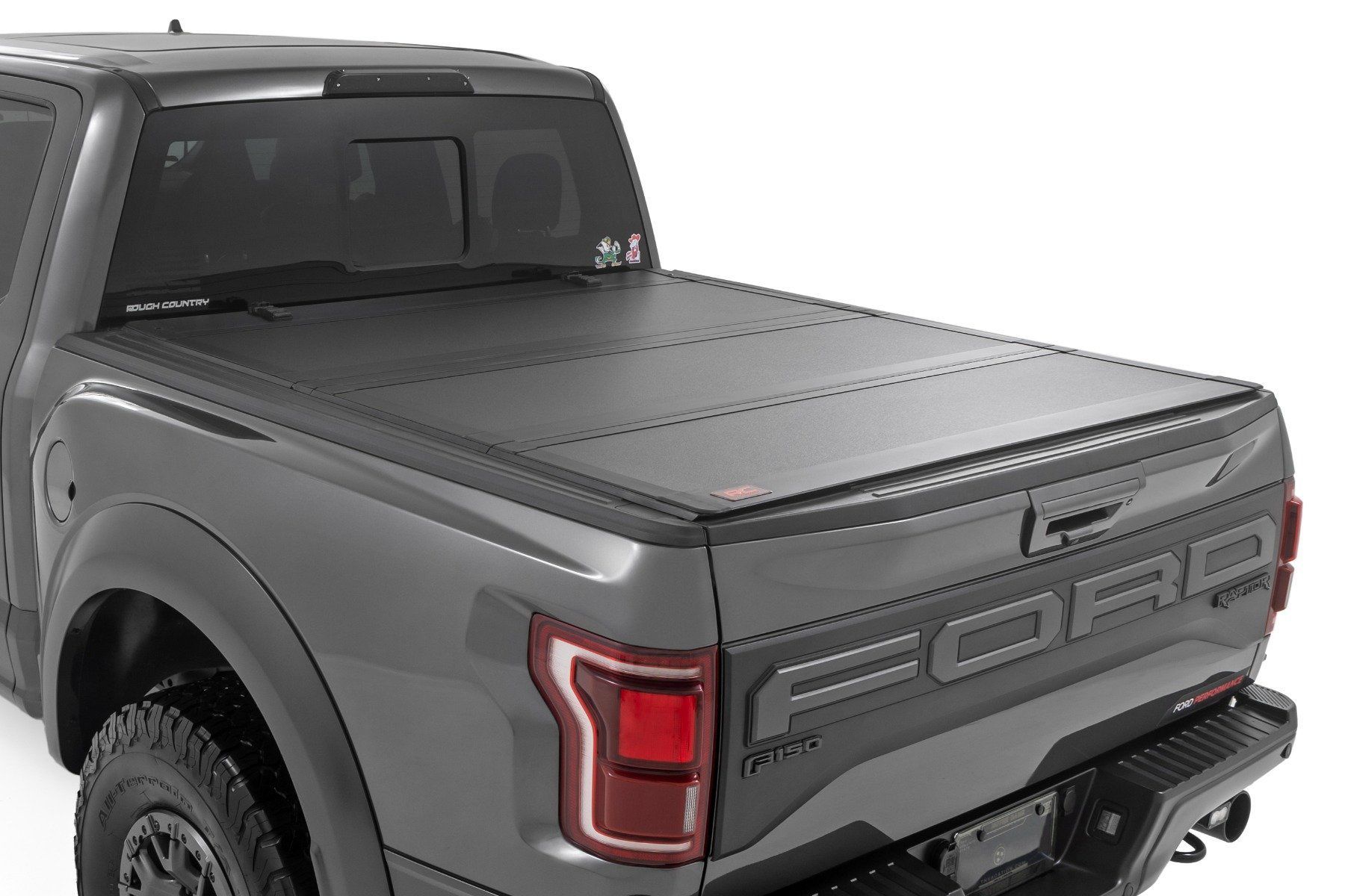 Gray pickup truck with a black, tri-fold tonneau cover.