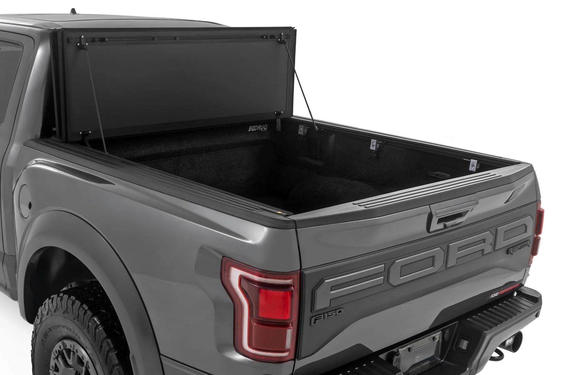 Gray pickup truck with a black, open bed cover.