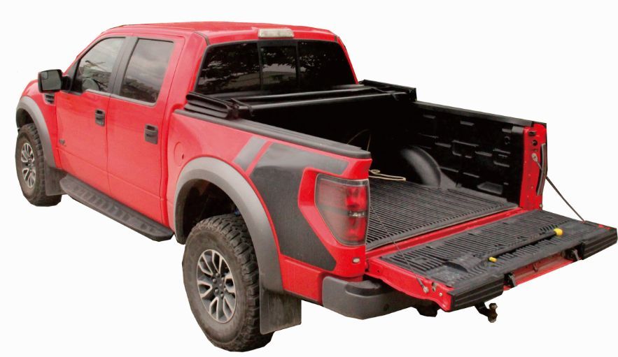 Red Ford Raptor pickup truck with its tailgate open and bed accessible.