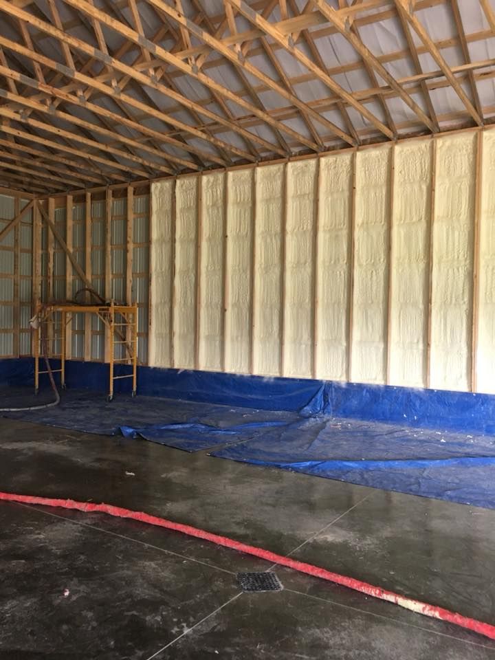 A large room with a lot of foam on the walls and a blue tarp on the floor.