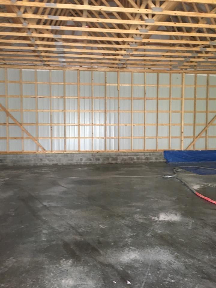 The inside of a building under construction with a concrete floor