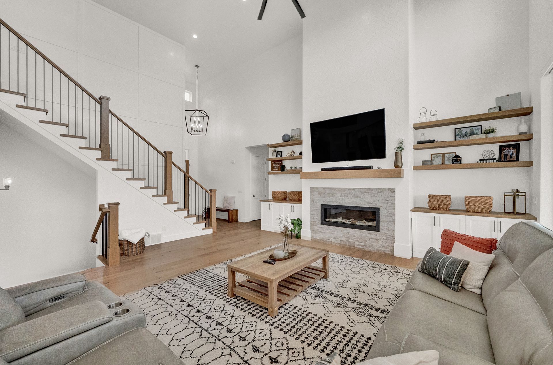 A living room with a couch , coffee table , fireplace and television.