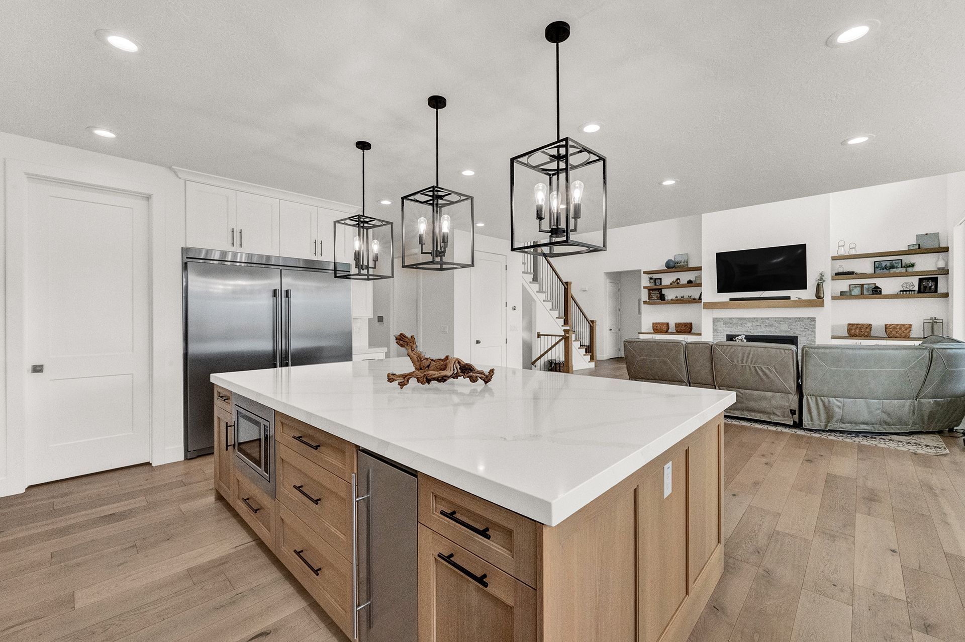 A kitchen with a large island and stainless steel appliances.