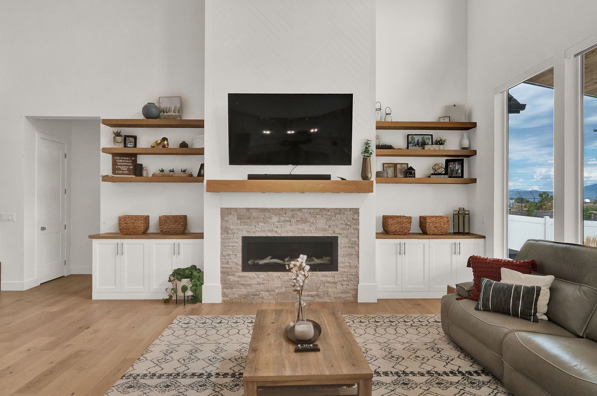 A living room with a fireplace and a flat screen tv
