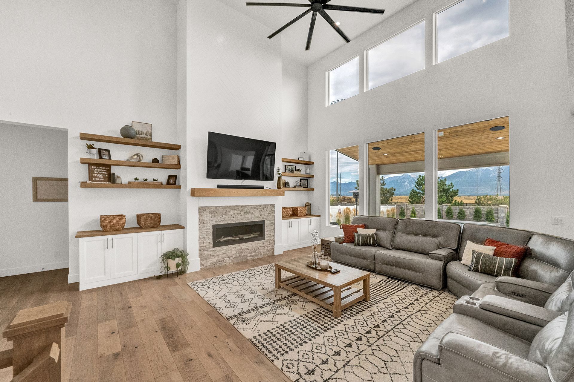 A living room with a couch , chairs , coffee table and television.