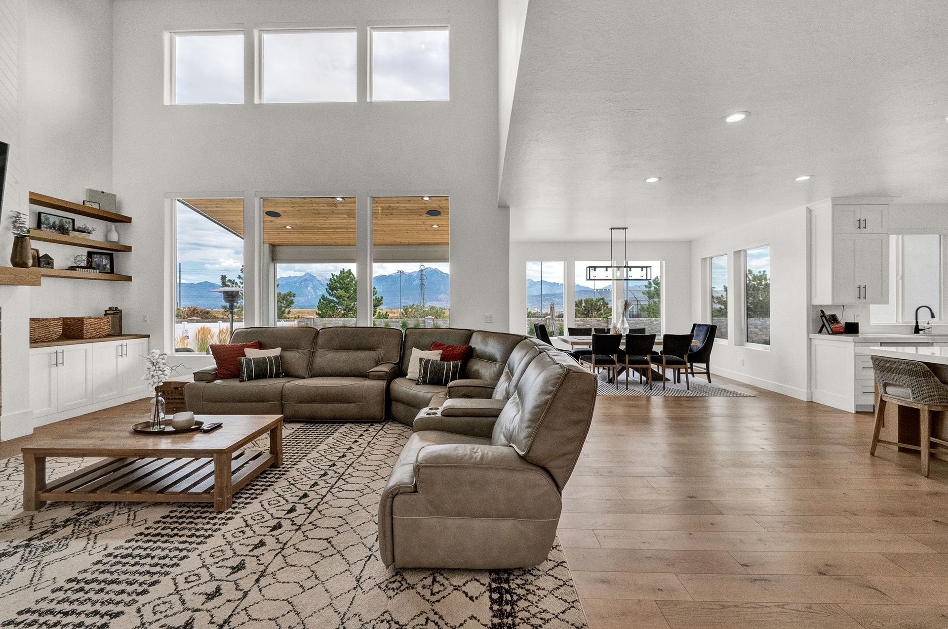 A living room with a large sectional couch and a coffee table
