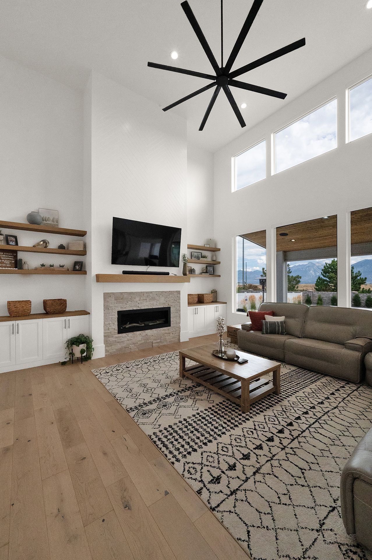 A living room with a fireplace , couch , coffee table and television.