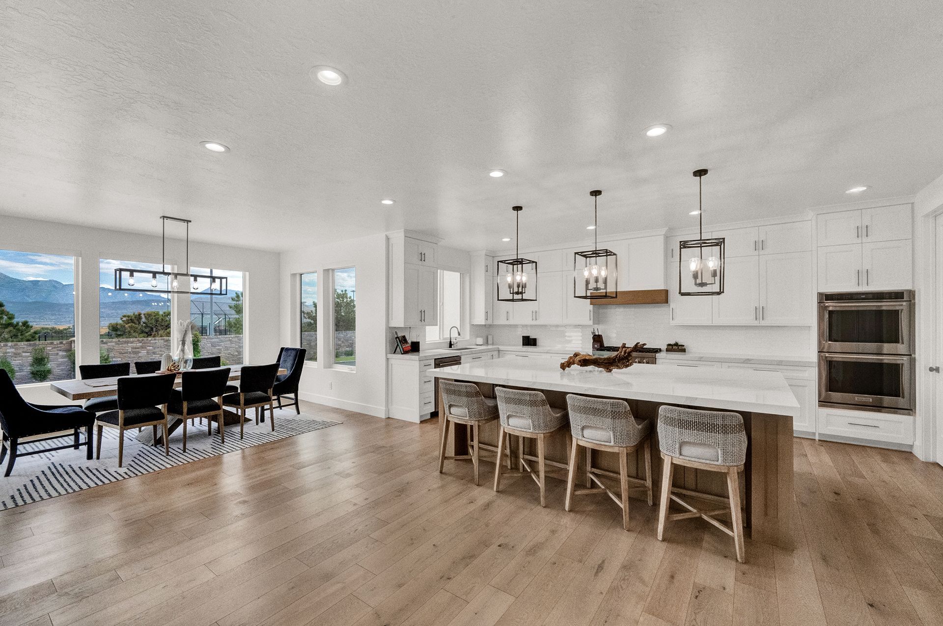 A large kitchen with a large island and a dining room in the background.