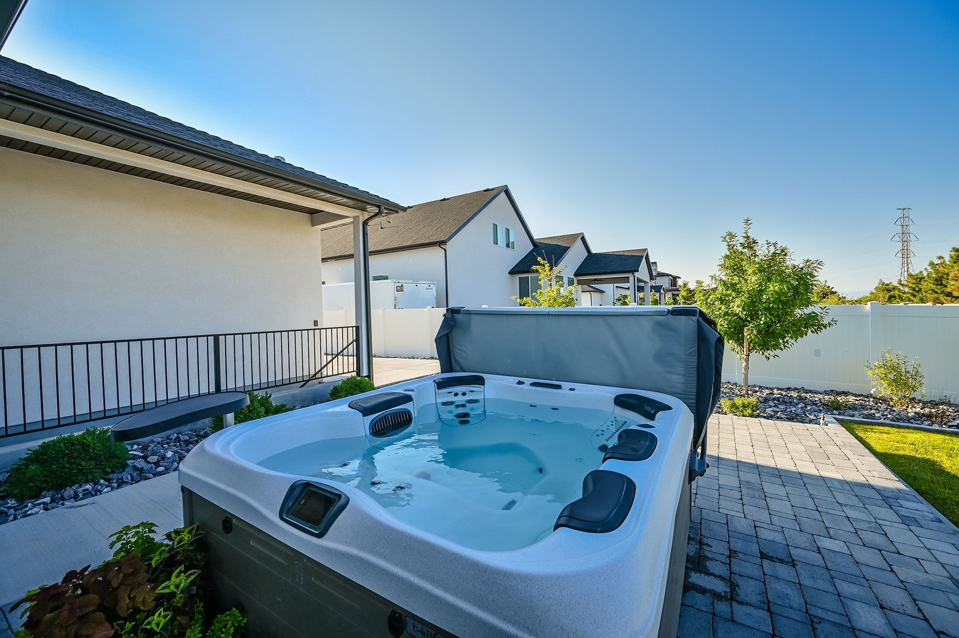 A hot tub is sitting in the backyard of a house.