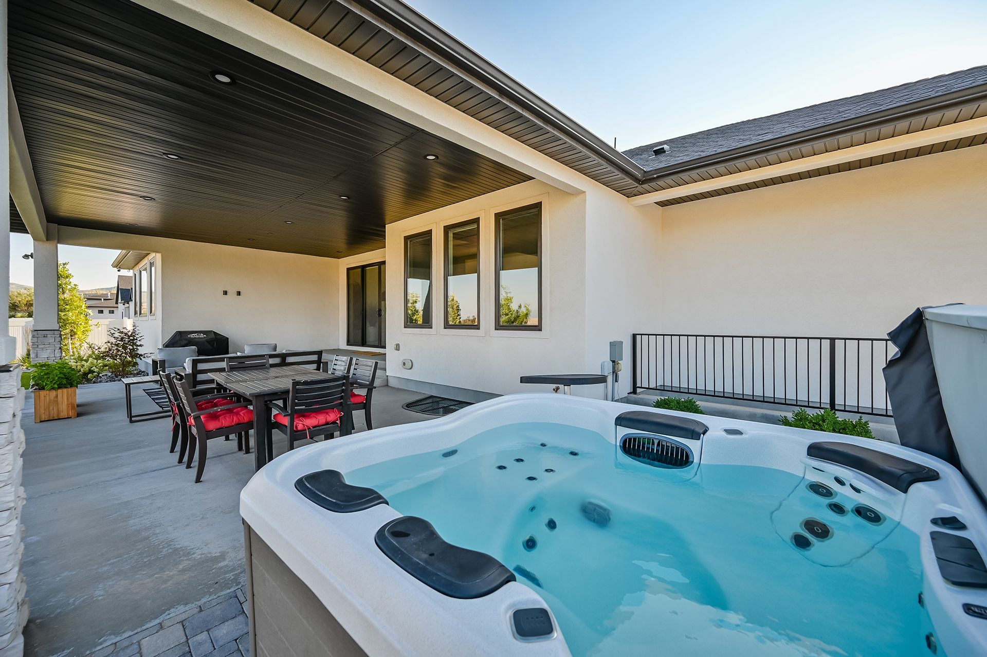 There is a hot tub in the backyard of a house.