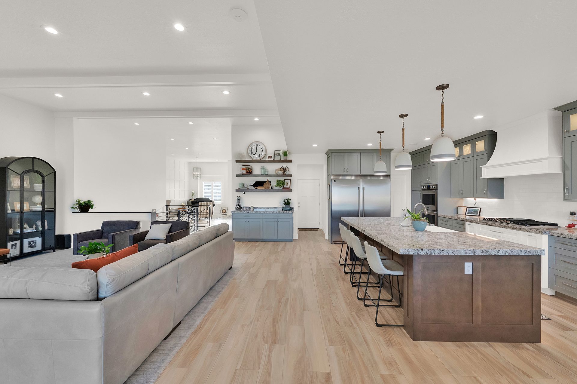 A living room and kitchen in a house with hardwood floors.