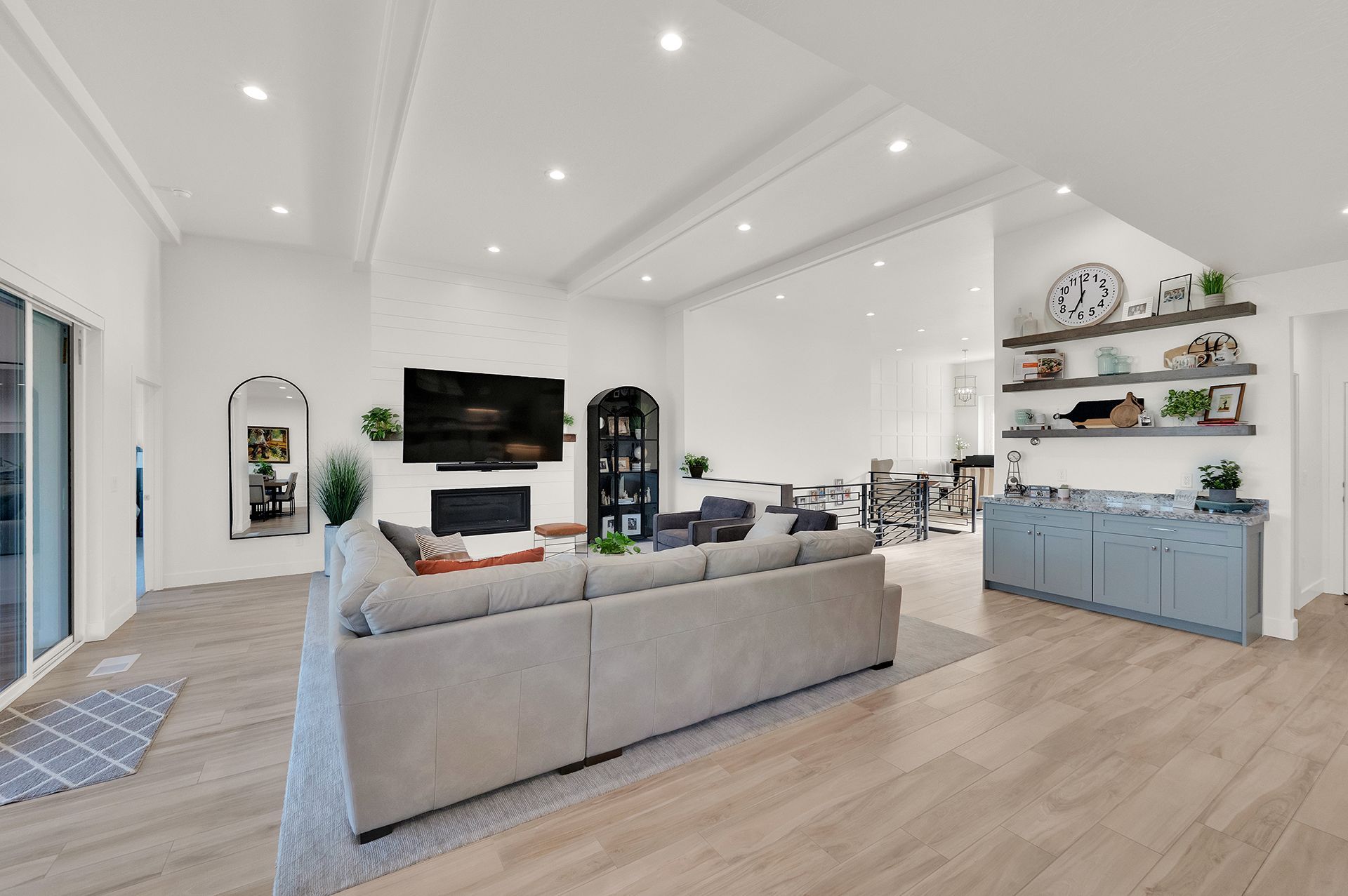 A living room with a large couch and a flat screen tv.
