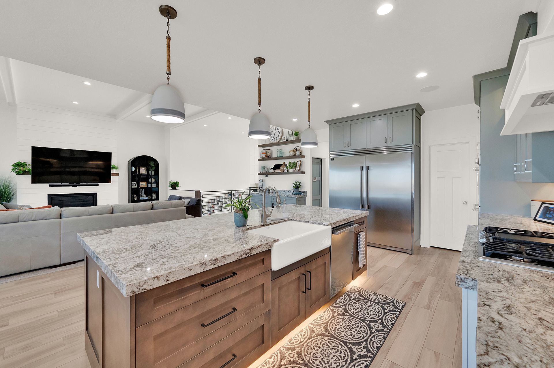 A kitchen with granite counter tops and stainless steel appliances.
