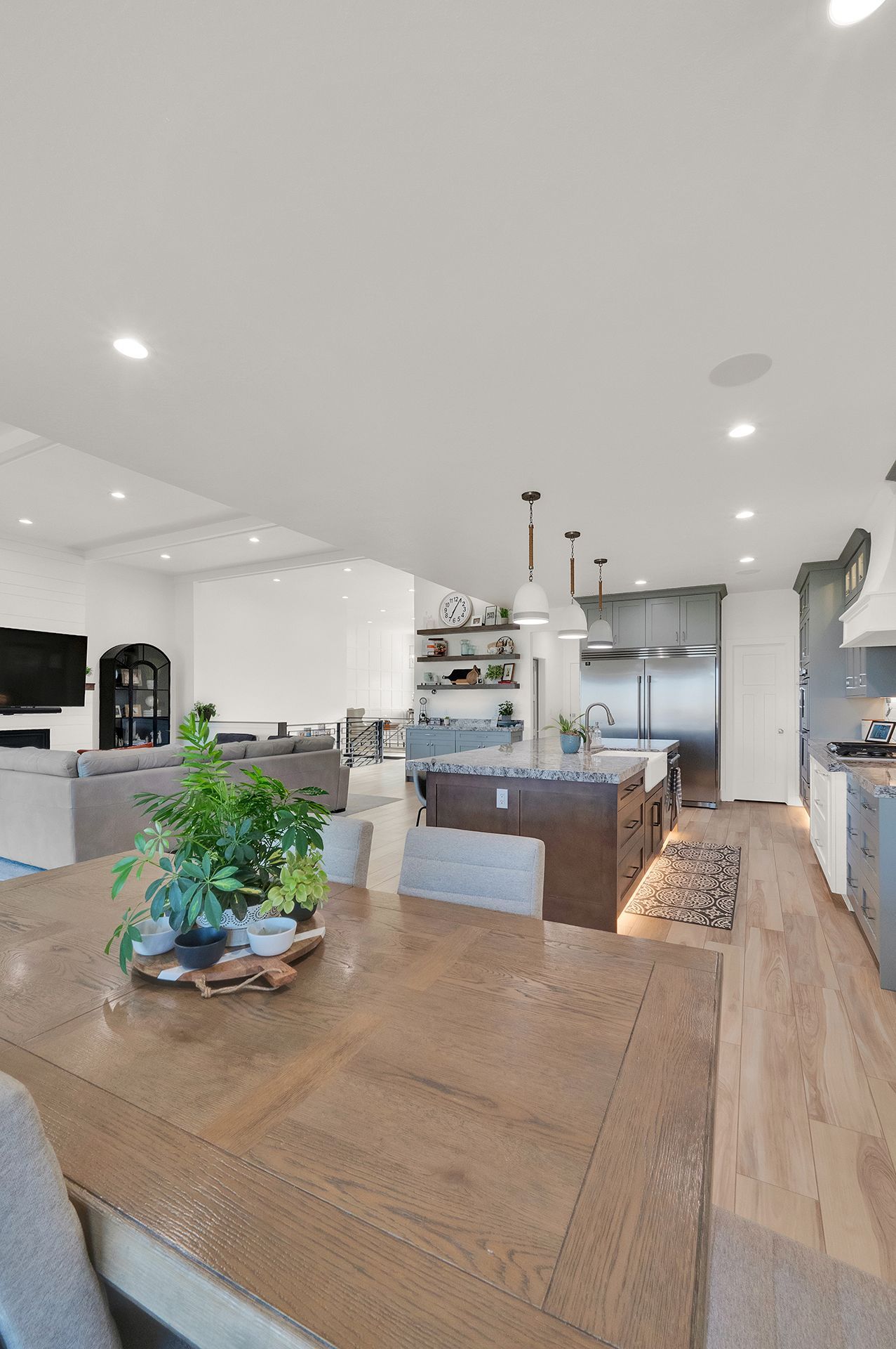 A dining table in a kitchen with a plant on it.