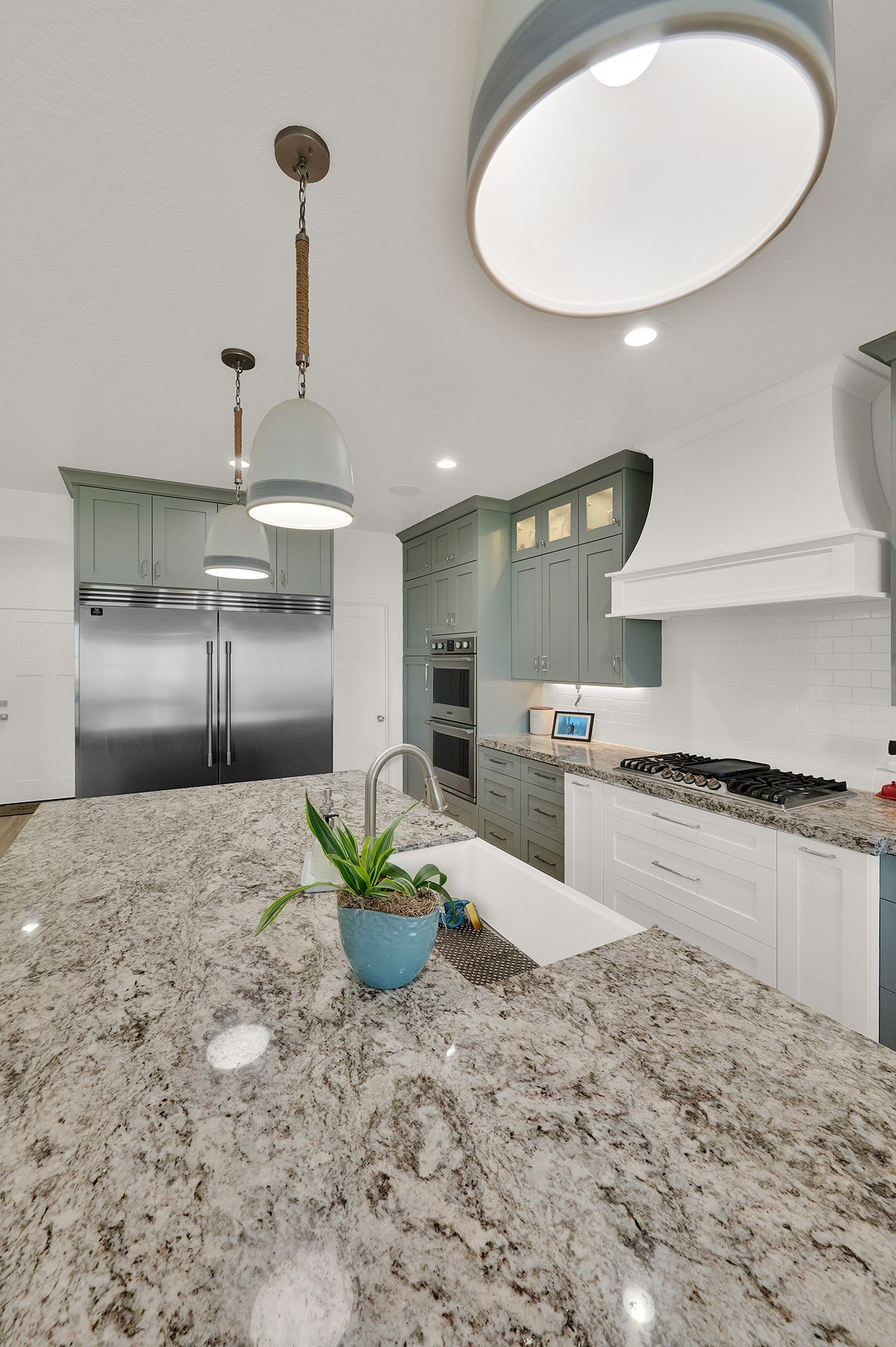 A kitchen with granite counter tops and stainless steel appliances