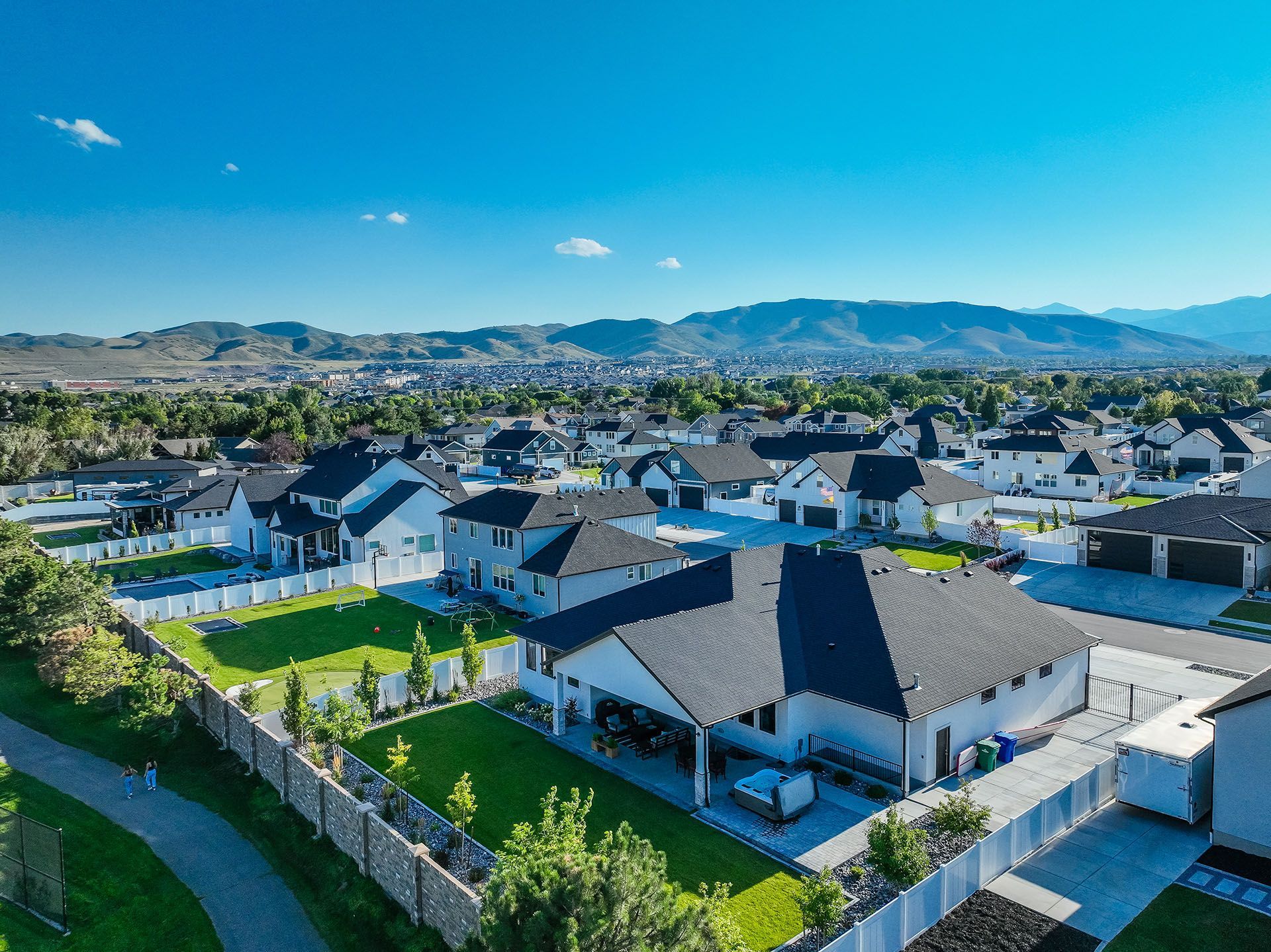 An aerial view of a residential neighborhood with mountains in the background.