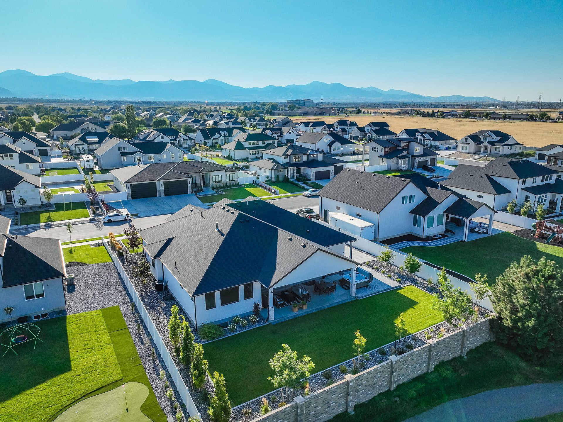 An aerial view of a residential neighborhood with mountains in the background.