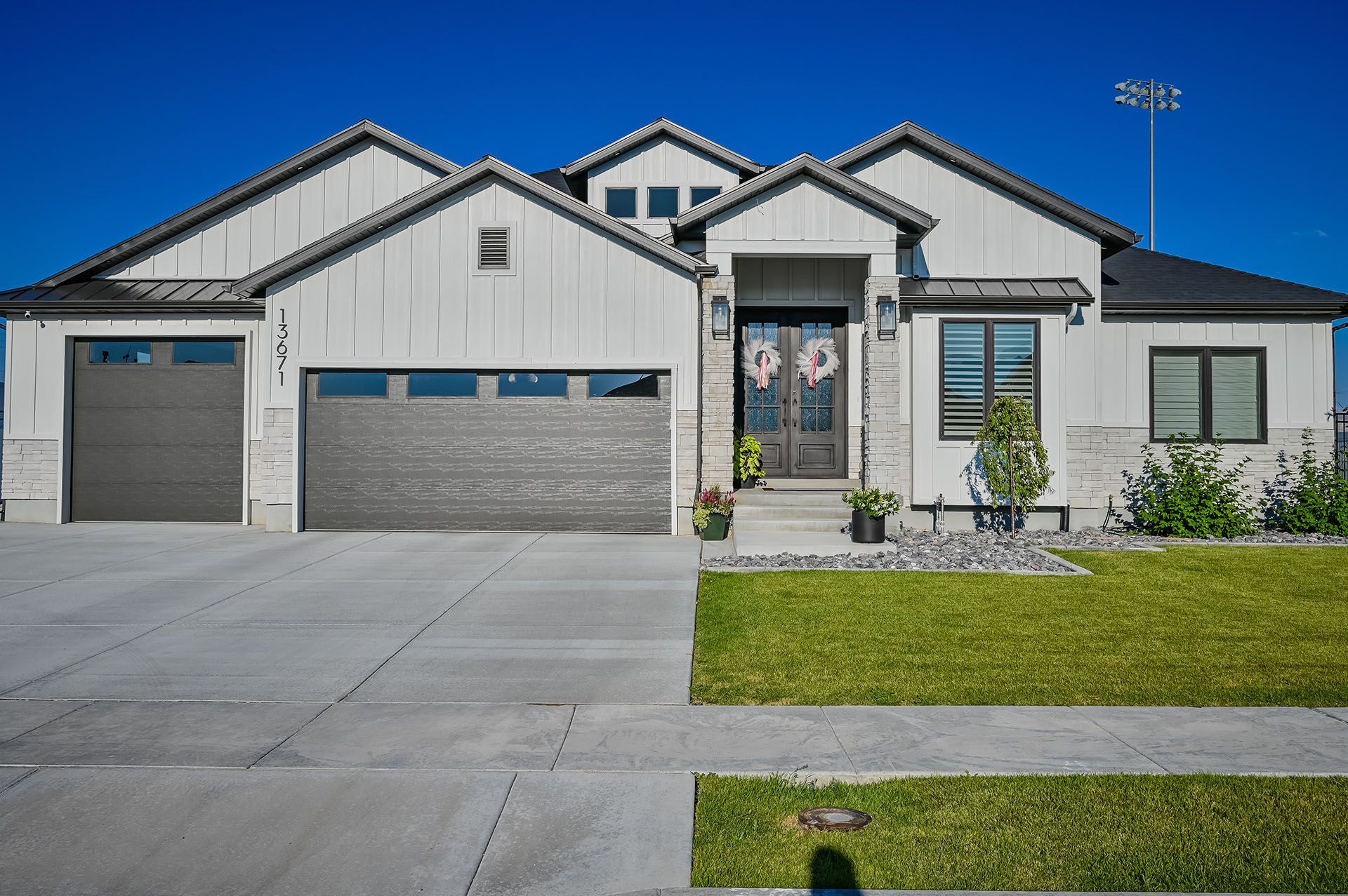 A large white house with a gray garage door